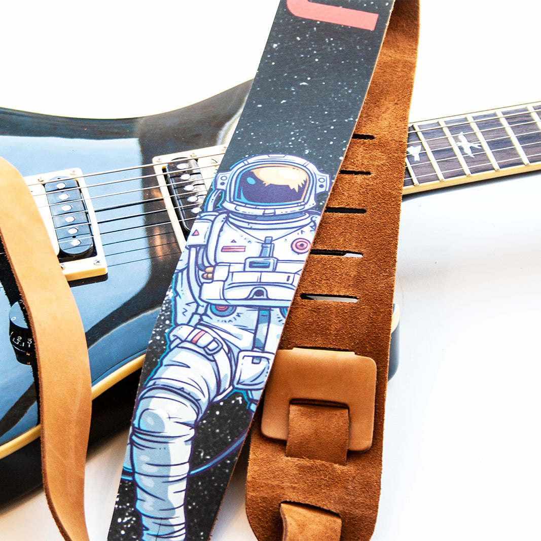 Spaceman printed on a leather guitar strap.