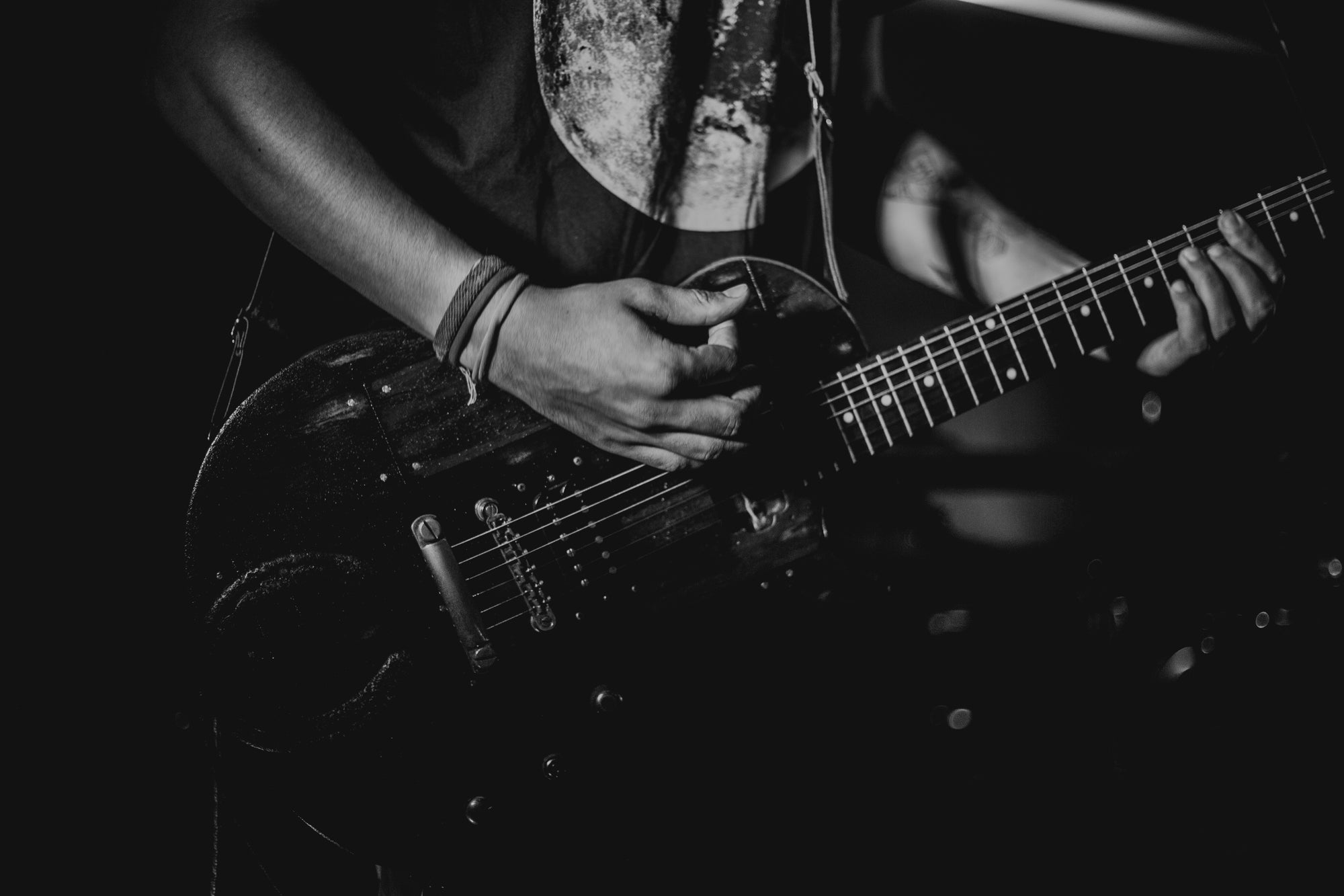 Black and white photo of a guitar player.