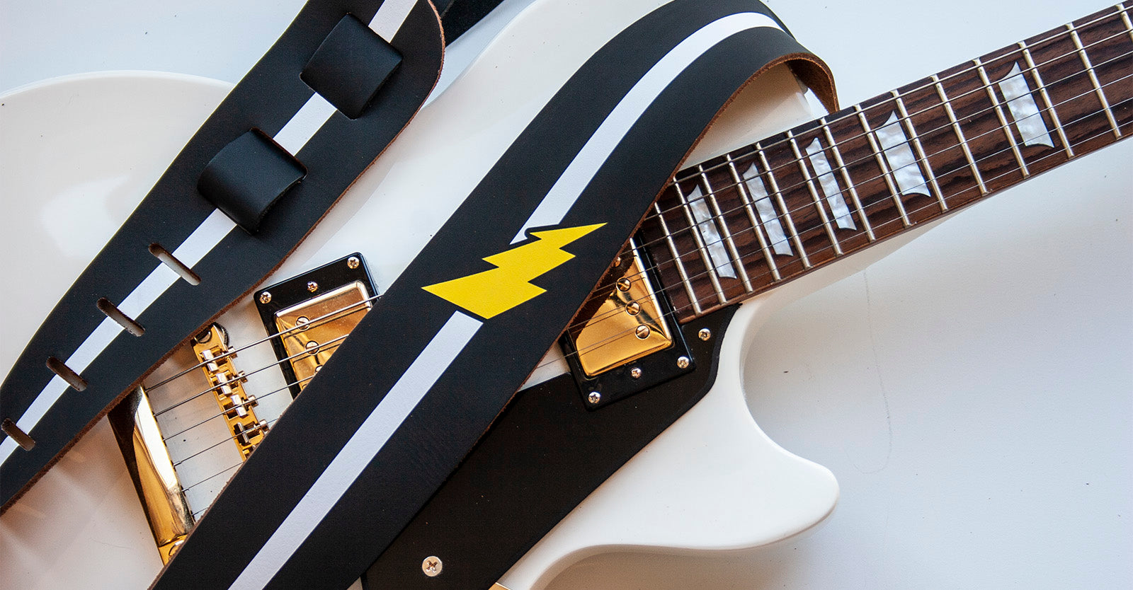 Guitar with a guitar strap. 