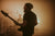 Playing a guitar in the light. On stage with a cool guitar strap.