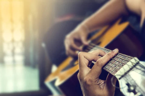 Playing jazz music on a acoustic guitar. 